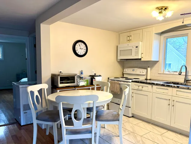 a kitchen with a dining table and chairs