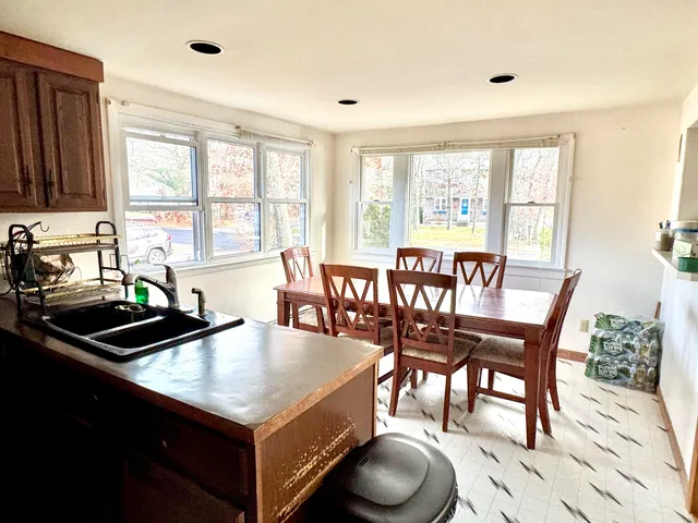 a view of a dining room with furniture window and outside view