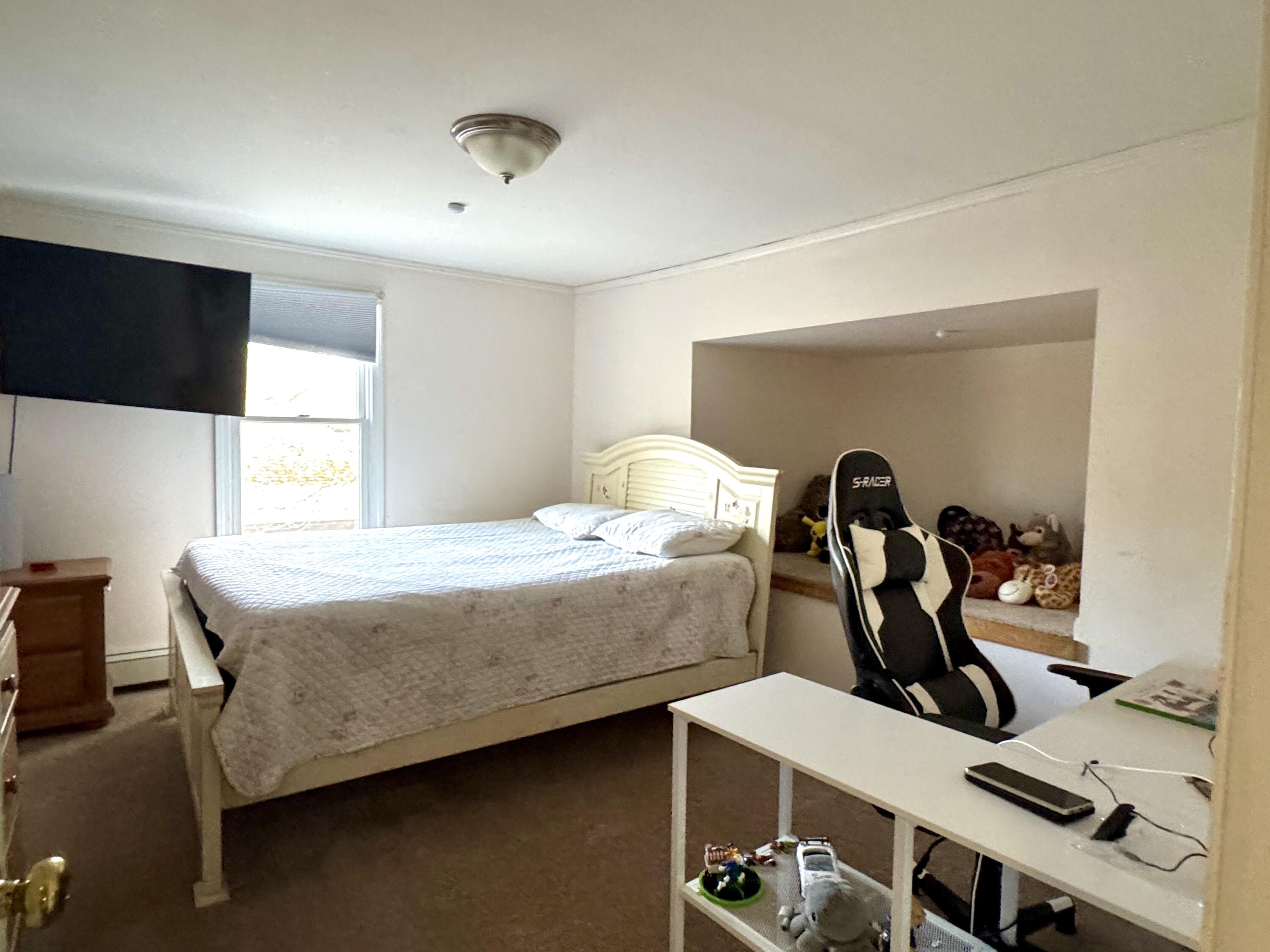 299 Winslow Gray Road West Yarmouth, MA 02673 - Photo 7 of 19 a bedroom with a bed and a desk