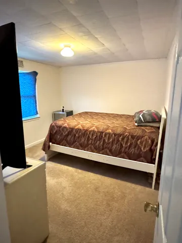 a living room with a bed and furniture