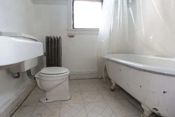 a bathroom with a sink a toilet and bathtub