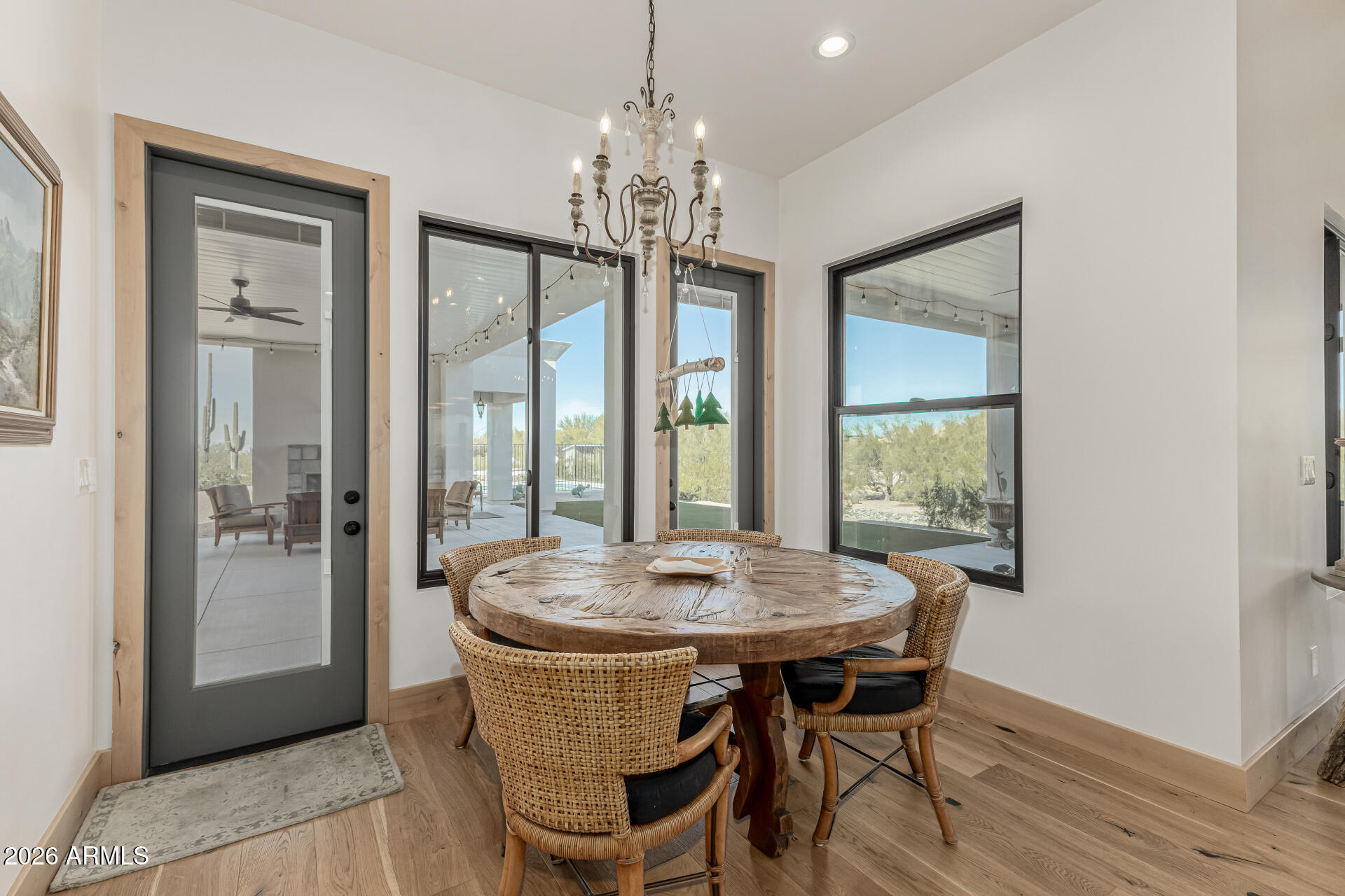 31210 North 68th Street Cave Creek, AZ 85331 - Photo 16 of 61 a dining room with furniture a chandelier and wooden floor