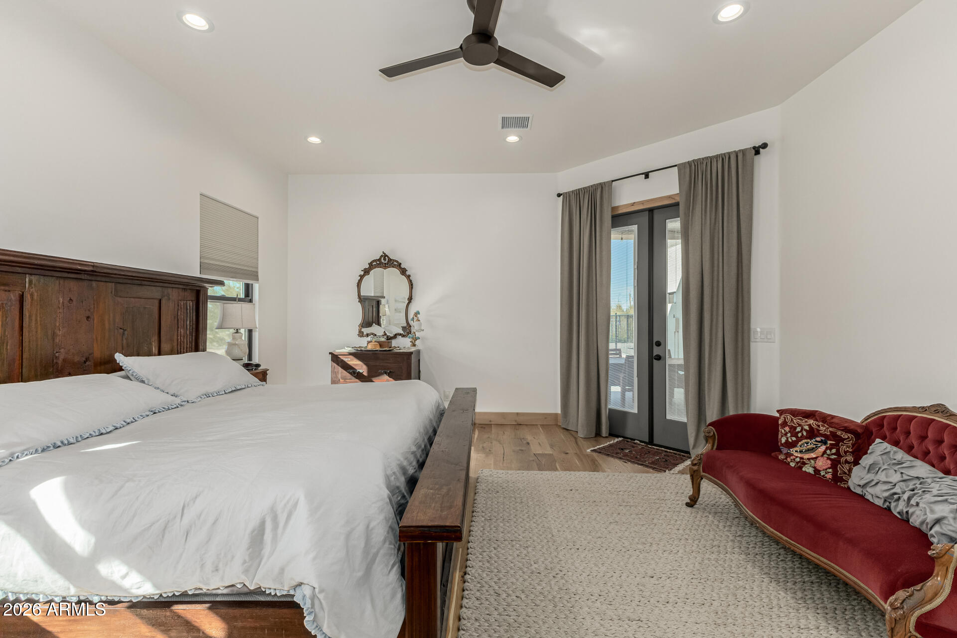31210 North 68th Street Cave Creek, AZ 85331 - Photo 25 of 61 a bedroom with a bed and a chandelier