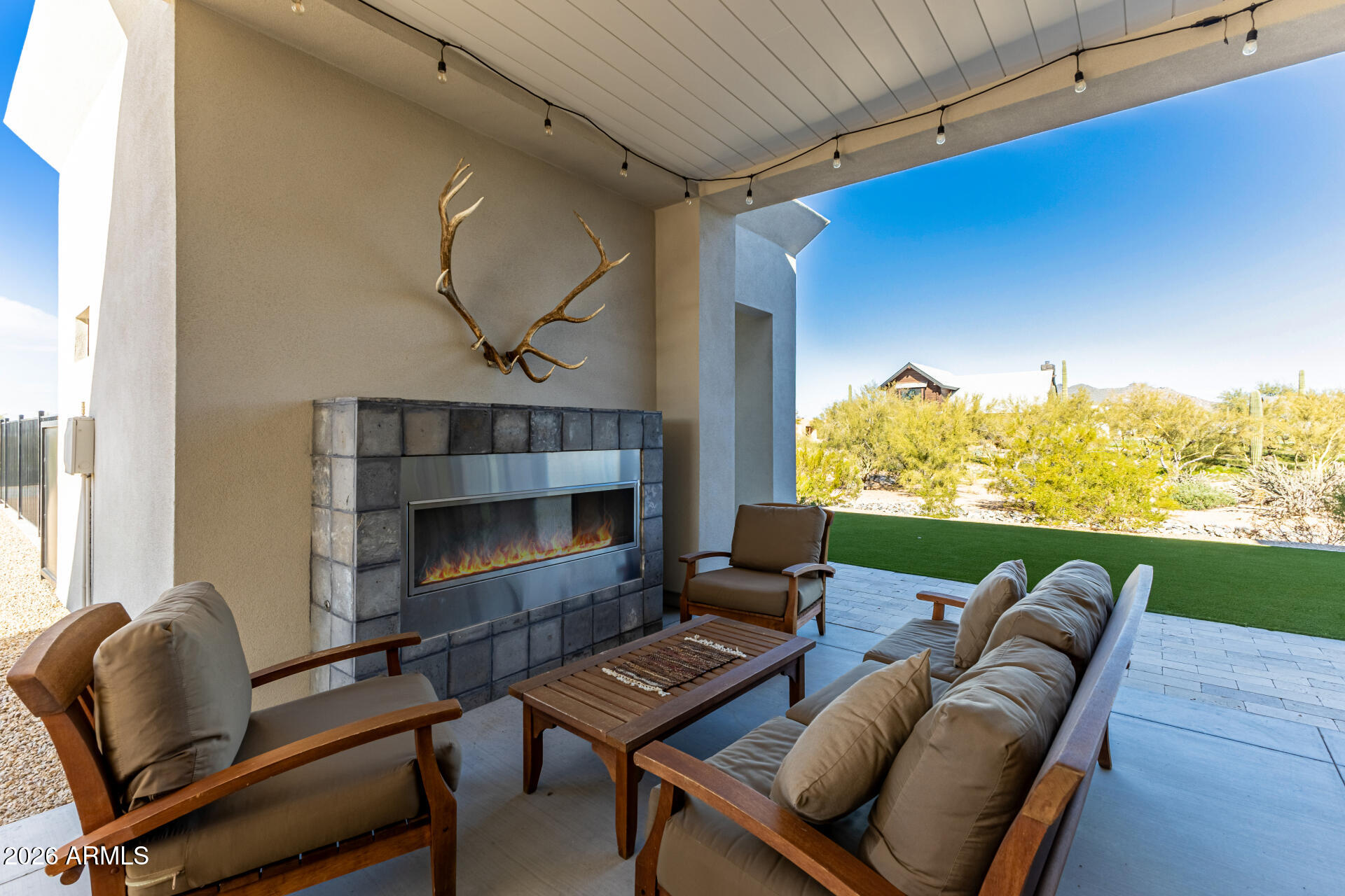 31210 North 68th Street Cave Creek, AZ 85331 - Photo 38 of 61 a living room with furniture a fireplace and a floor to ceiling window