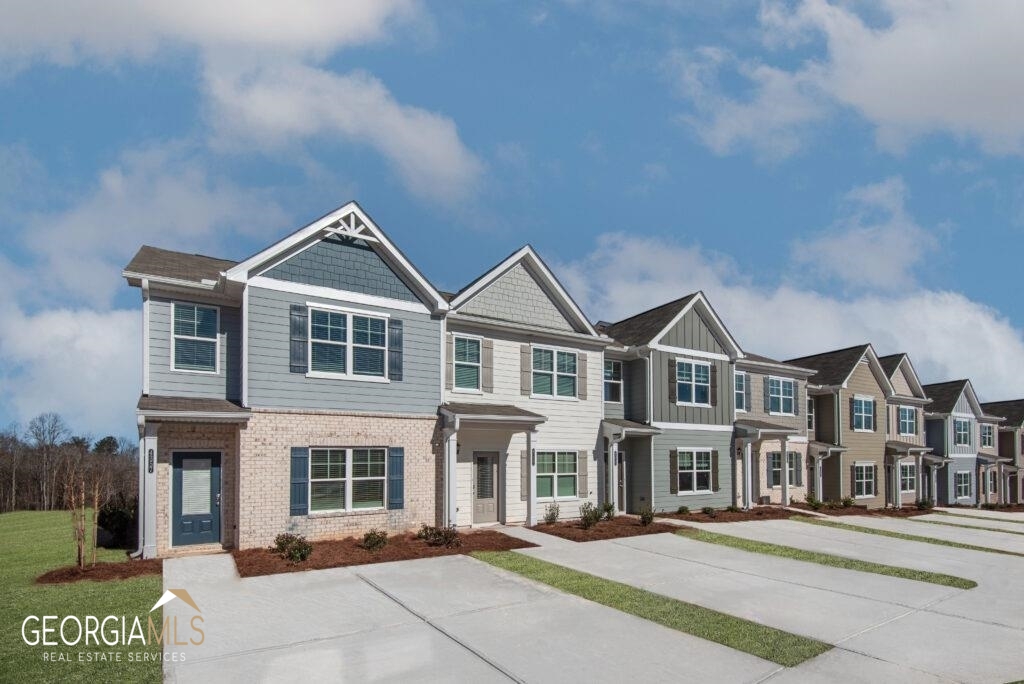 a front view of a building with a yard