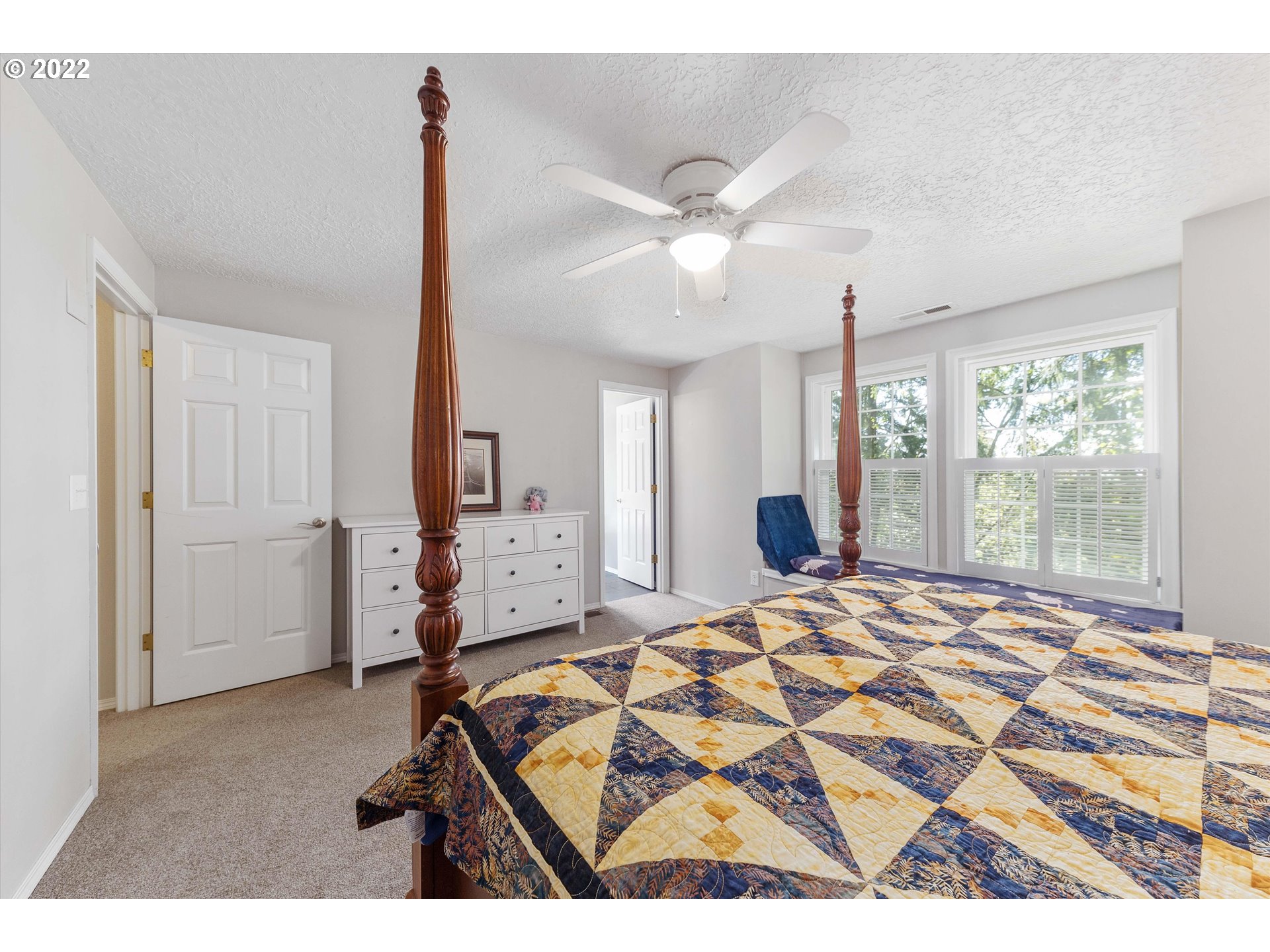 17212 Southeast Royer Road Damascus, OR 97089 - Photo 13 of 32 a bedroom with a bed and a chandelier