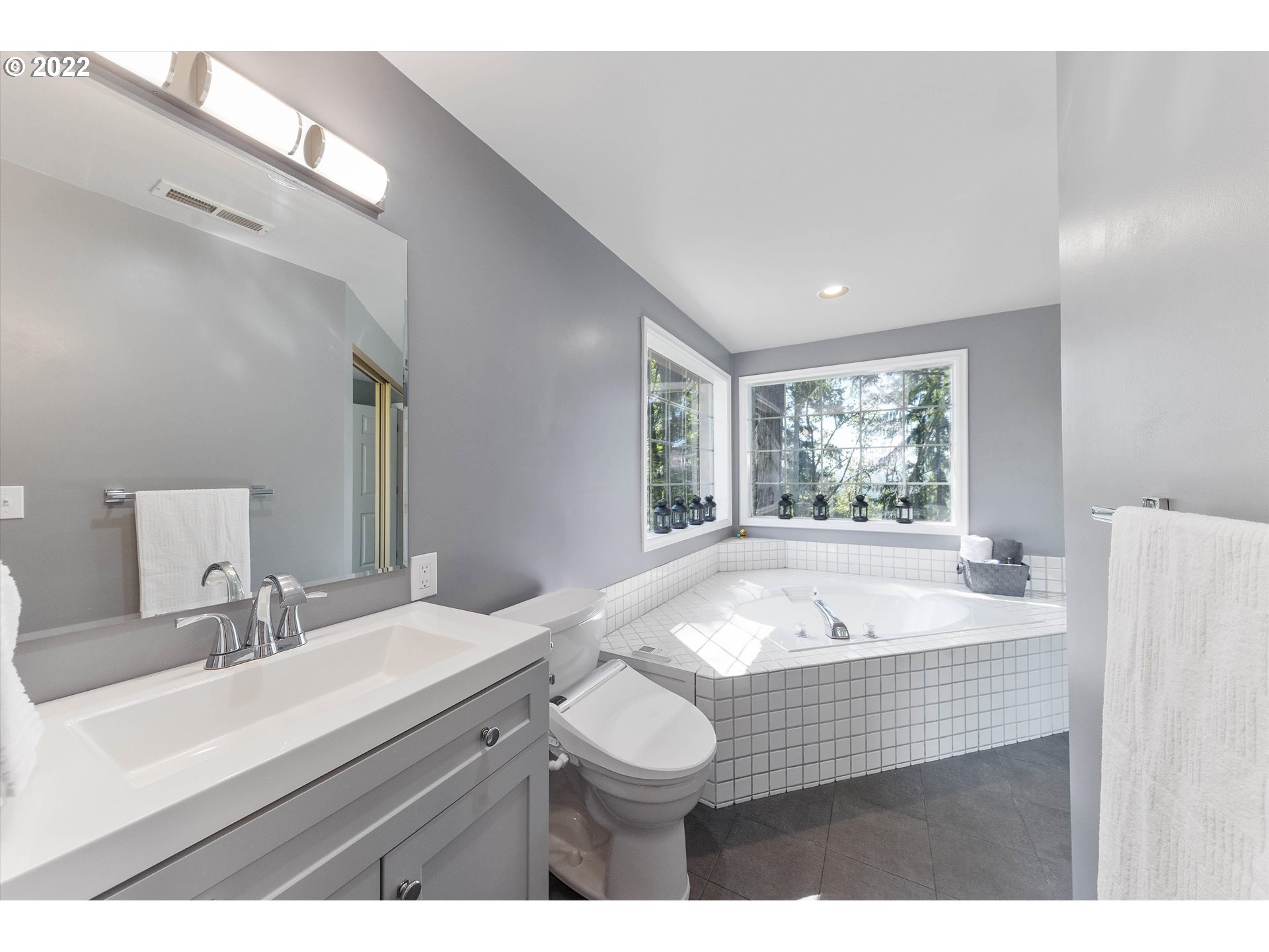 17212 Southeast Royer Road Damascus, OR 97089 - Photo 15 of 32 a bathroom with a sink double vanity mirror and a bathtub