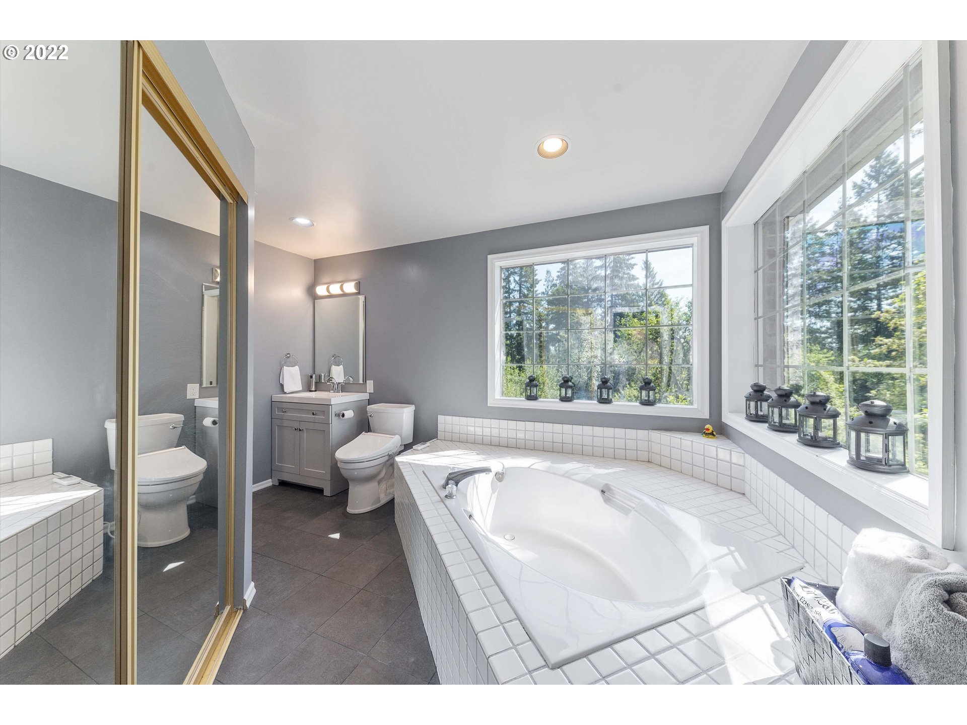 17212 Southeast Royer Road Damascus, OR 97089 - Photo 17 of 32 a spacious bathroom with a bathtub and a large window