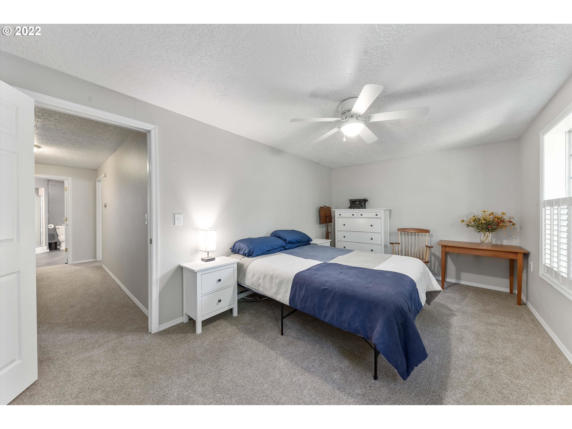 17212 Southeast Royer Road Damascus, OR 97089 - Photo 18 of 32 a bedroom with bed and a chandelier