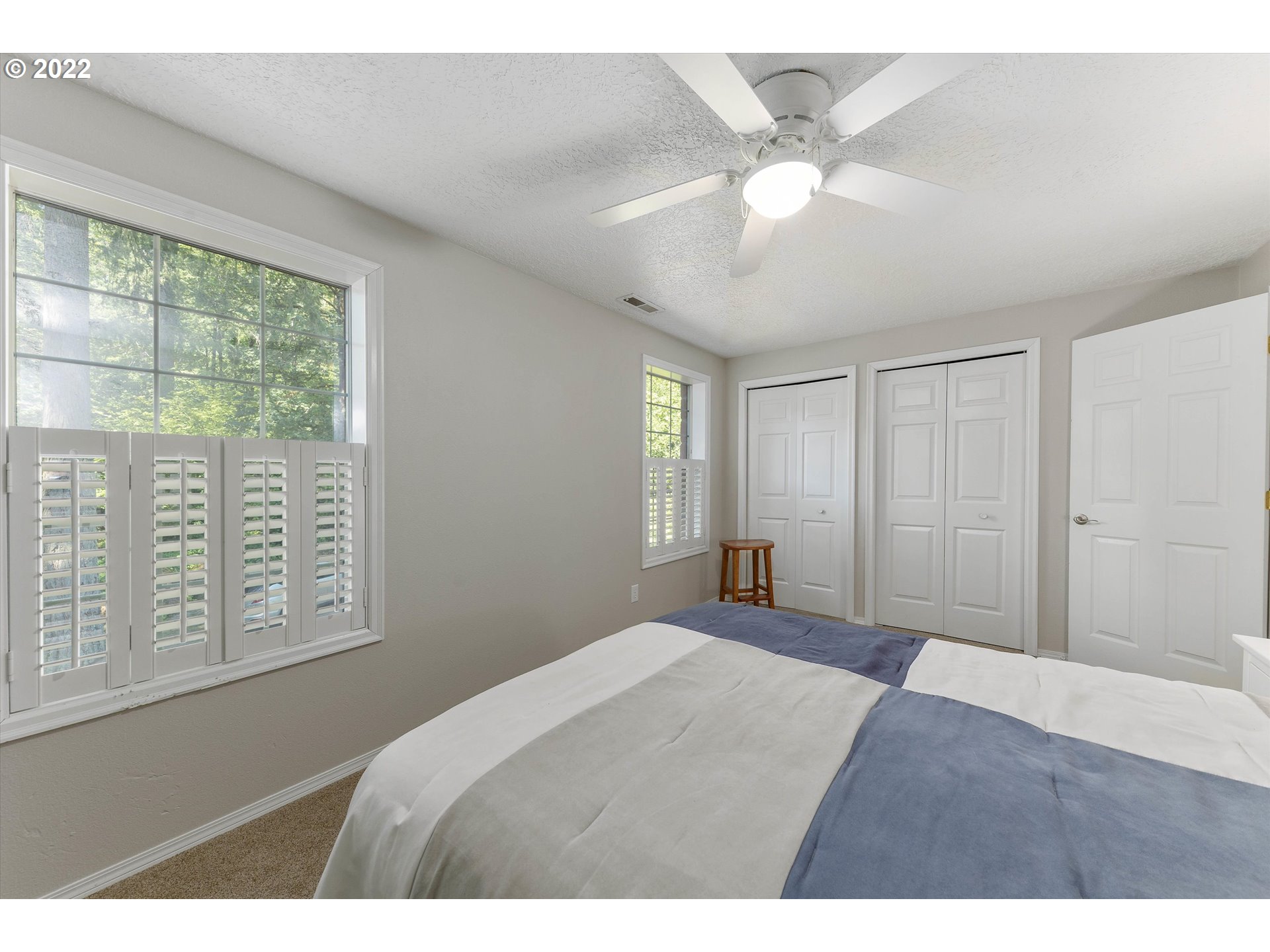 17212 Southeast Royer Road Damascus, OR 97089 - Photo 19 of 32 a bedroom with a large bed and a window
