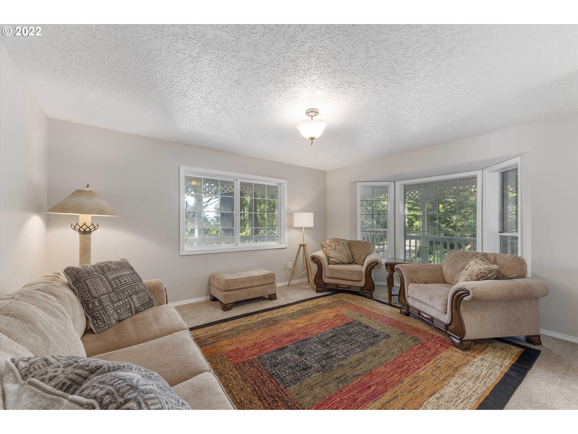 17212 Southeast Royer Road Damascus, OR 97089 - Photo 2 of 32 a bedroom with furniture and a large window