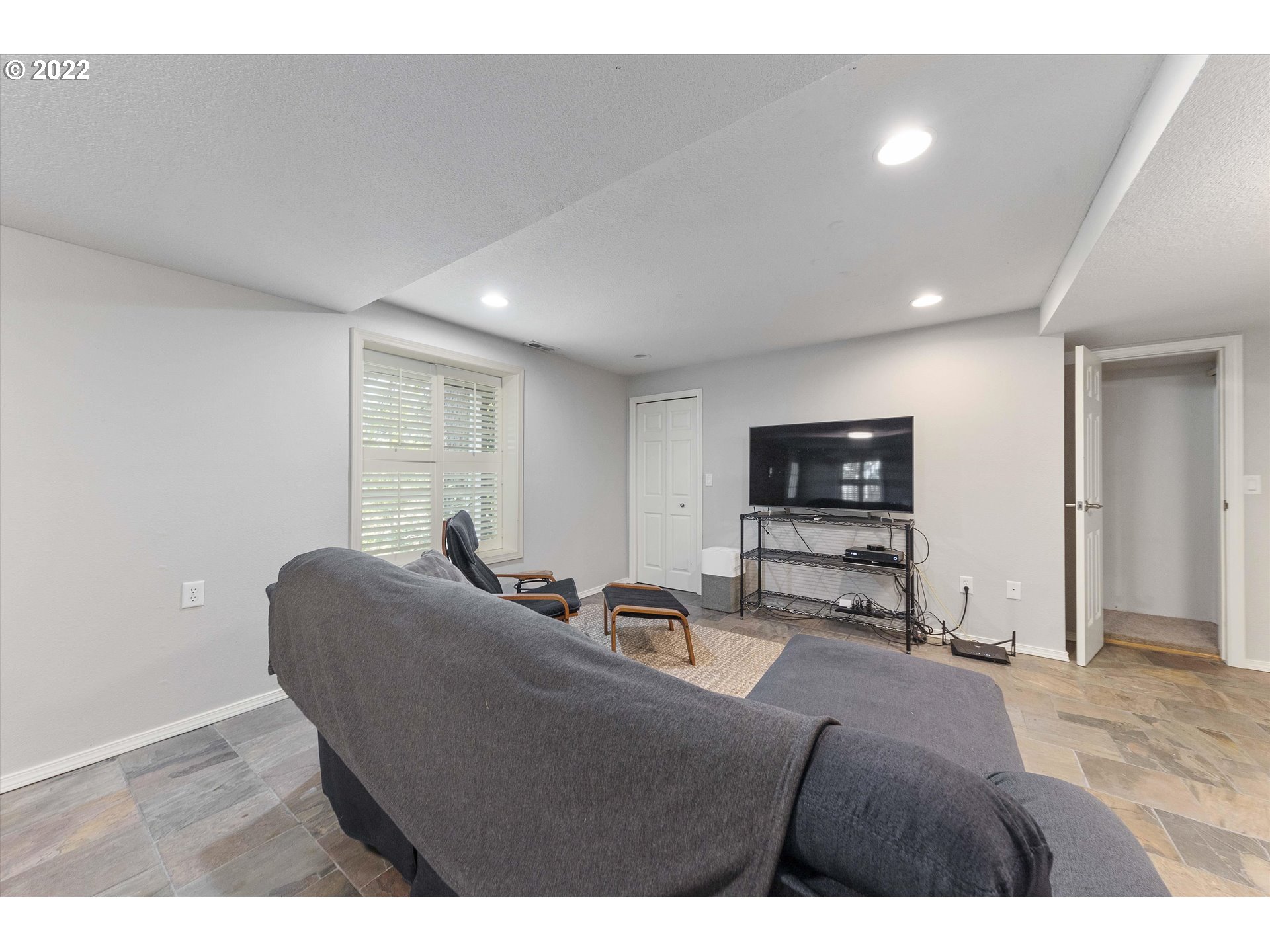 17212 Southeast Royer Road Damascus, OR 97089 - Photo 23 of 32 a living room with furniture and a flat screen tv