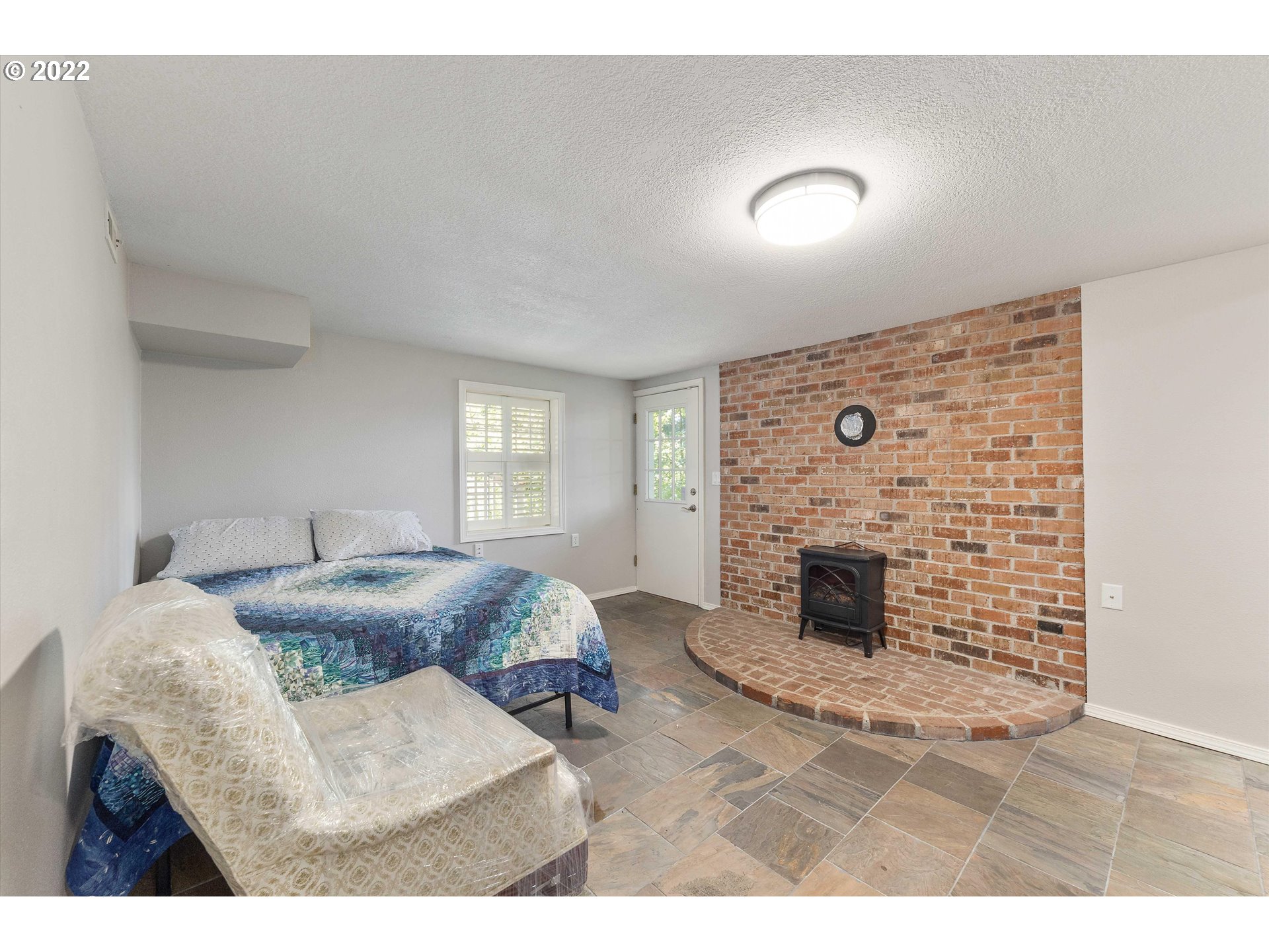 17212 Southeast Royer Road Damascus, OR 97089 - Photo 24 of 32 a living room with furniture and a fireplace