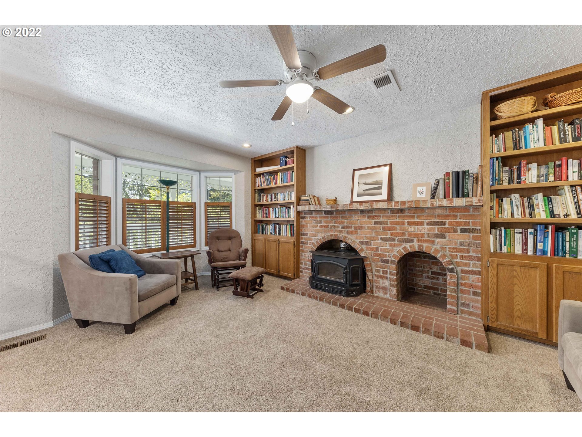 17212 Southeast Royer Road Damascus, OR 97089 - Photo 5 of 32 a living room with furniture and a fireplace