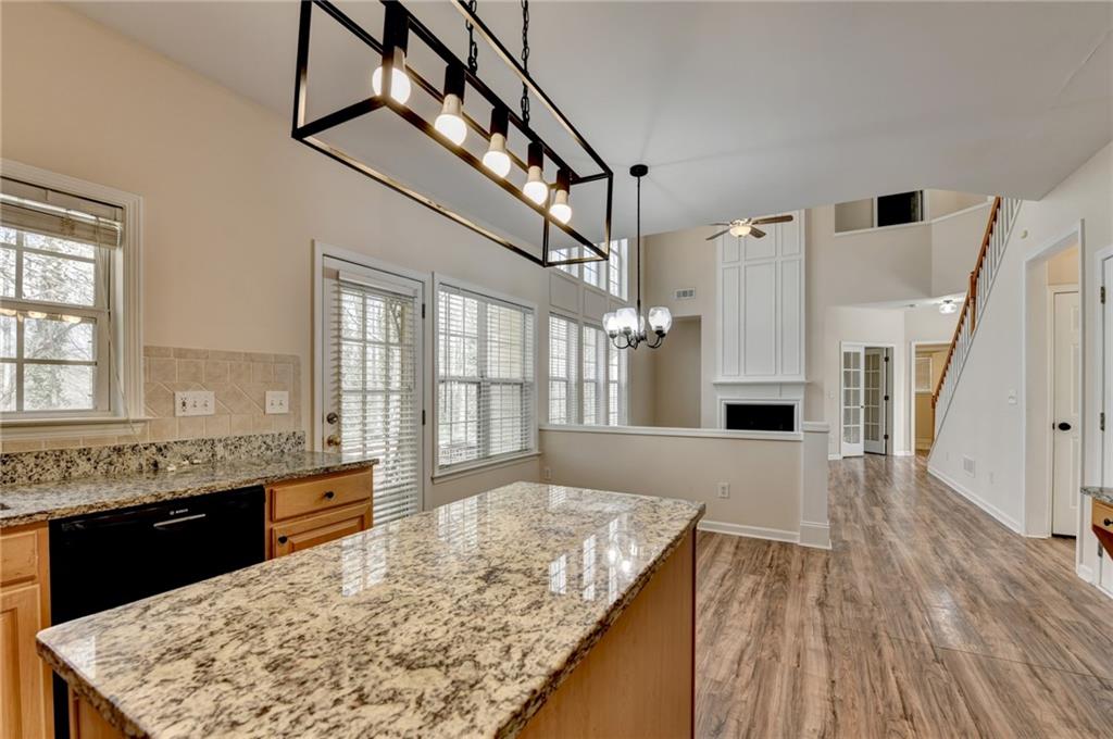 100 Hawnley Trc Northwest Suwanee, GA 30024 - Photo 27 of 58 a large kitchen with kitchen island granite countertop wooden floor and a sink