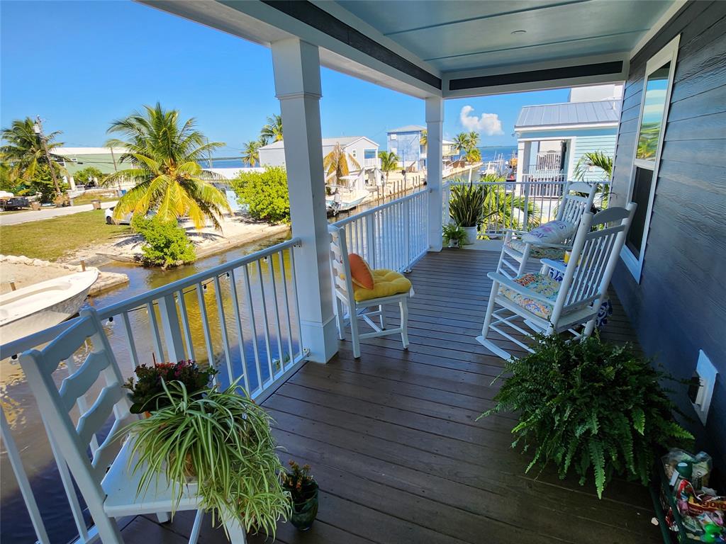 31547 Ave D Big Pine Key, FL 33043 - Photo 12 of 42 a view of a porch with potted plants