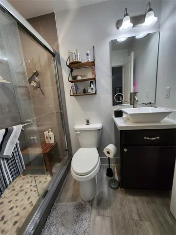 a bathroom with a toilet and a shower