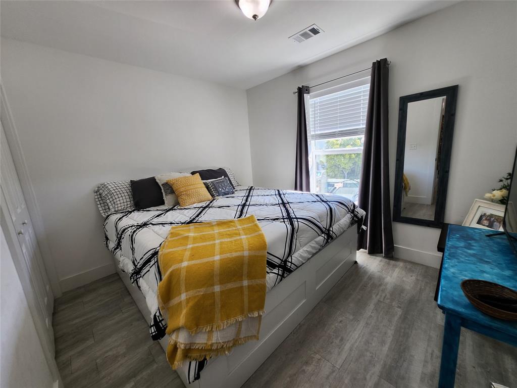 31547 Ave D Big Pine Key, FL 33043 - Photo 17 of 42 a bedroom with a bed and wooden floor