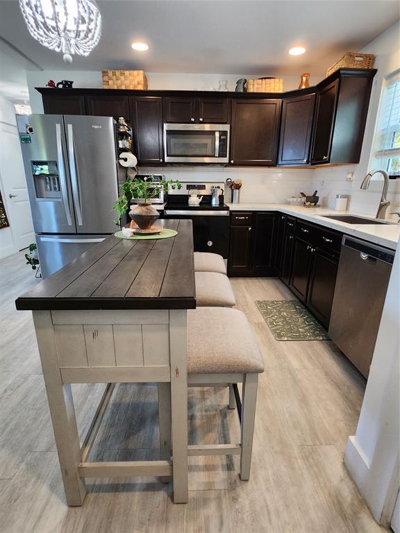 31547 Ave D Big Pine Key, FL 33043 - Photo 25 of 42 a kitchen with stainless steel appliances kitchen island granite countertop a sink and a stove