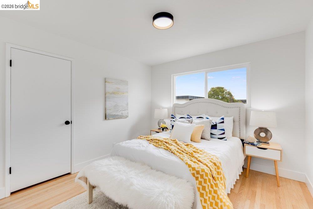 1298 Ribbon Street Foster City, CA 94404 - Photo 52 of 86 Bright bedroom featuring light wood-finish flooring, white walls, and a modern ceiling light fixture