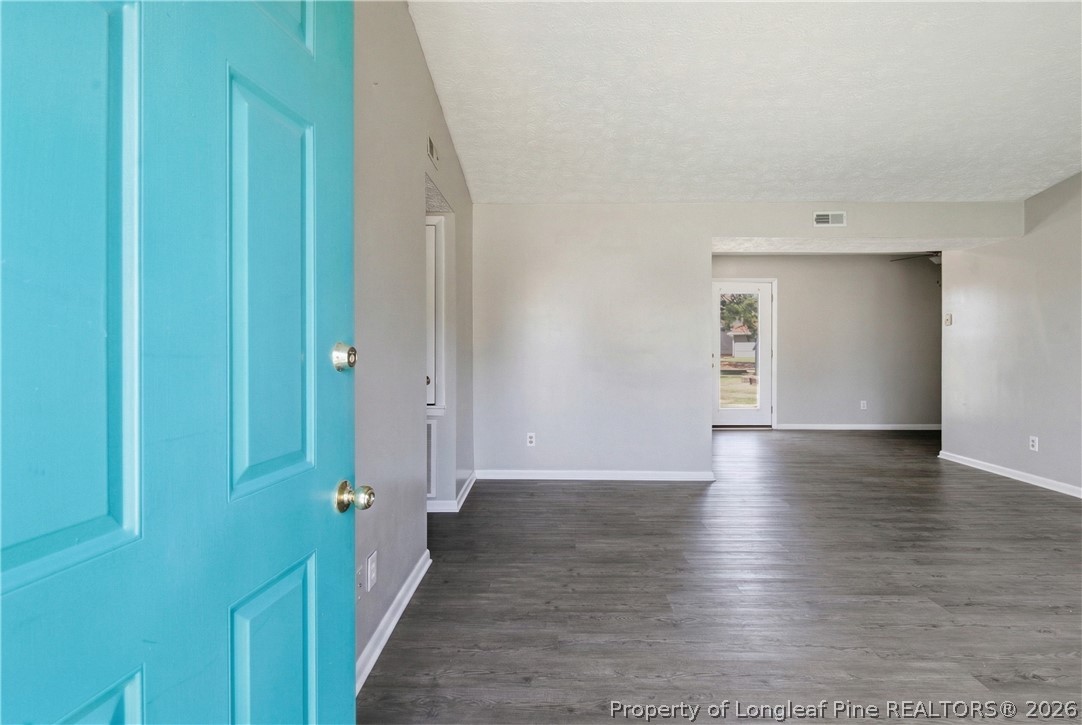 6319 Rustic Ridge Hope Mills, NC 28348 - Photo 4 of 39 a view of a hallway with wooden floor