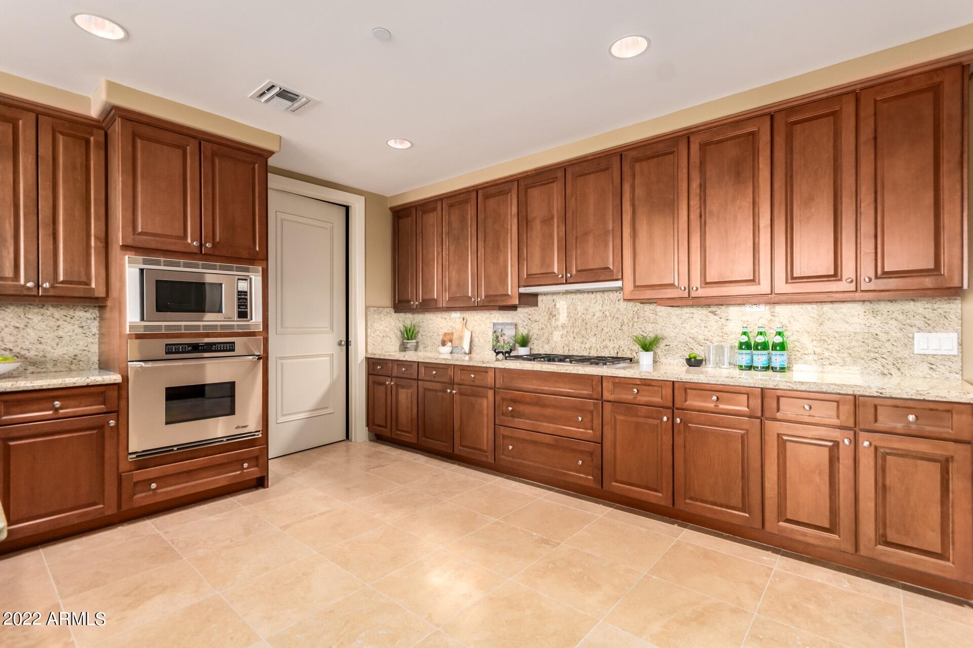 2211 East Camelback Road, Unit 1104 Phoenix, AZ 85016 - Photo 14 of 43 a kitchen with stainless steel appliances granite countertop a stove a sink dishwasher and a refrigerator