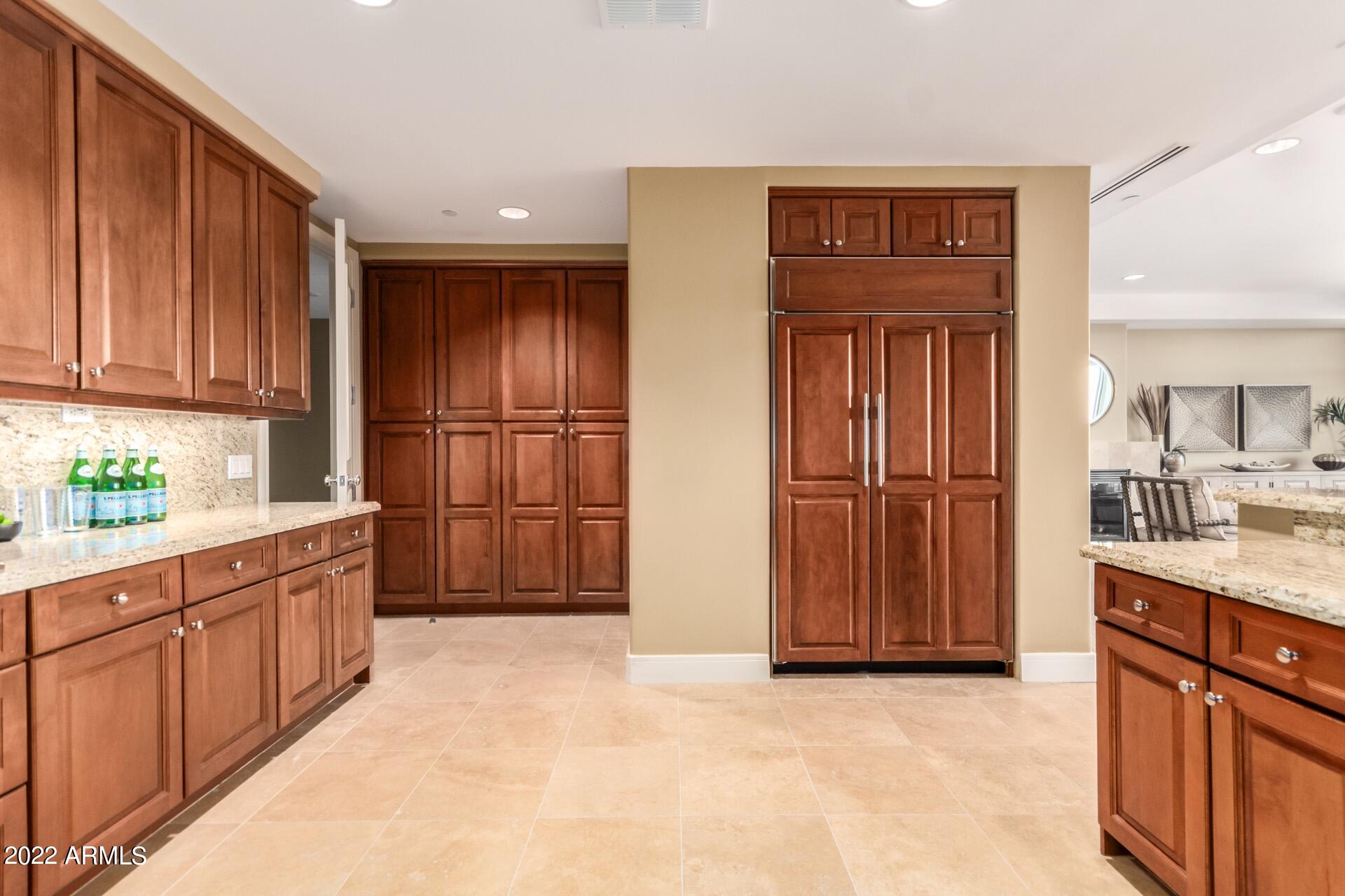 2211 East Camelback Road, Unit 1104 Phoenix, AZ 85016 - Photo 17 of 43 a kitchen with stainless steel appliances granite countertop a refrigerator and cabinets
