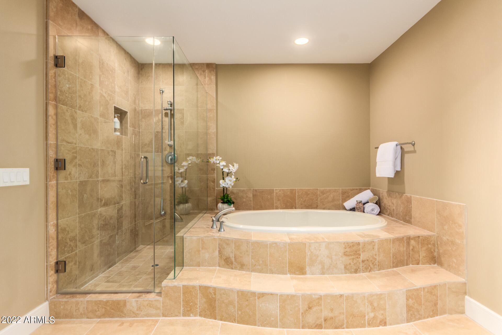2211 East Camelback Road, Unit 1104 Phoenix, AZ 85016 - Photo 23 of 43 a bathroom with a bathtub and a shower