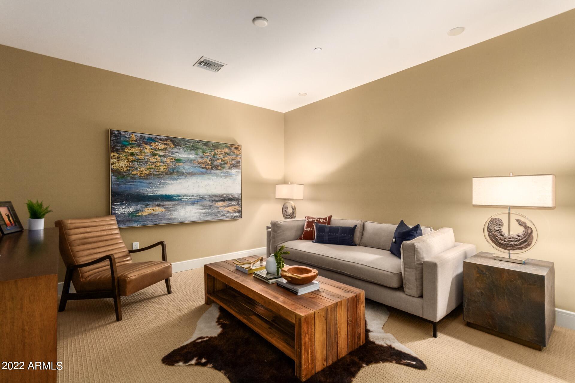 2211 East Camelback Road, Unit 1104 Phoenix, AZ 85016 - Photo 26 of 43 a living room with furniture a rug and a wall painting