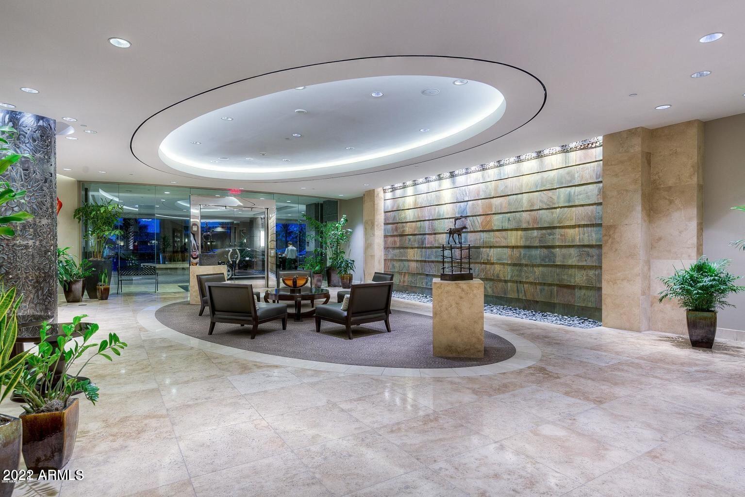 2211 East Camelback Road, Unit 1104 Phoenix, AZ 85016 - Photo 39 of 43 a lobby with furniture and potted plants