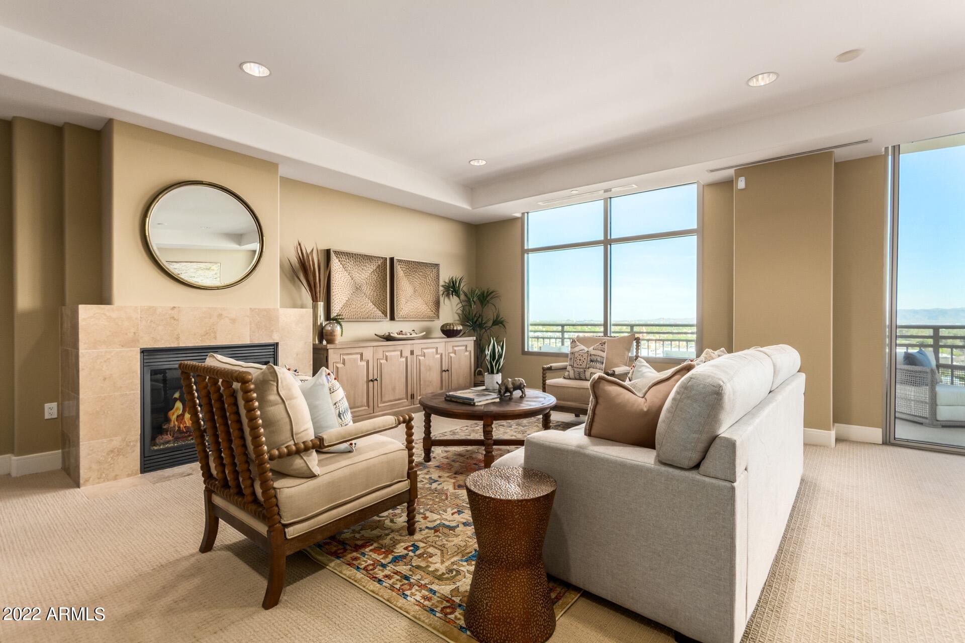 2211 East Camelback Road, Unit 1104 Phoenix, AZ 85016 - Photo 4 of 43 a living room with furniture a fireplace and a large window