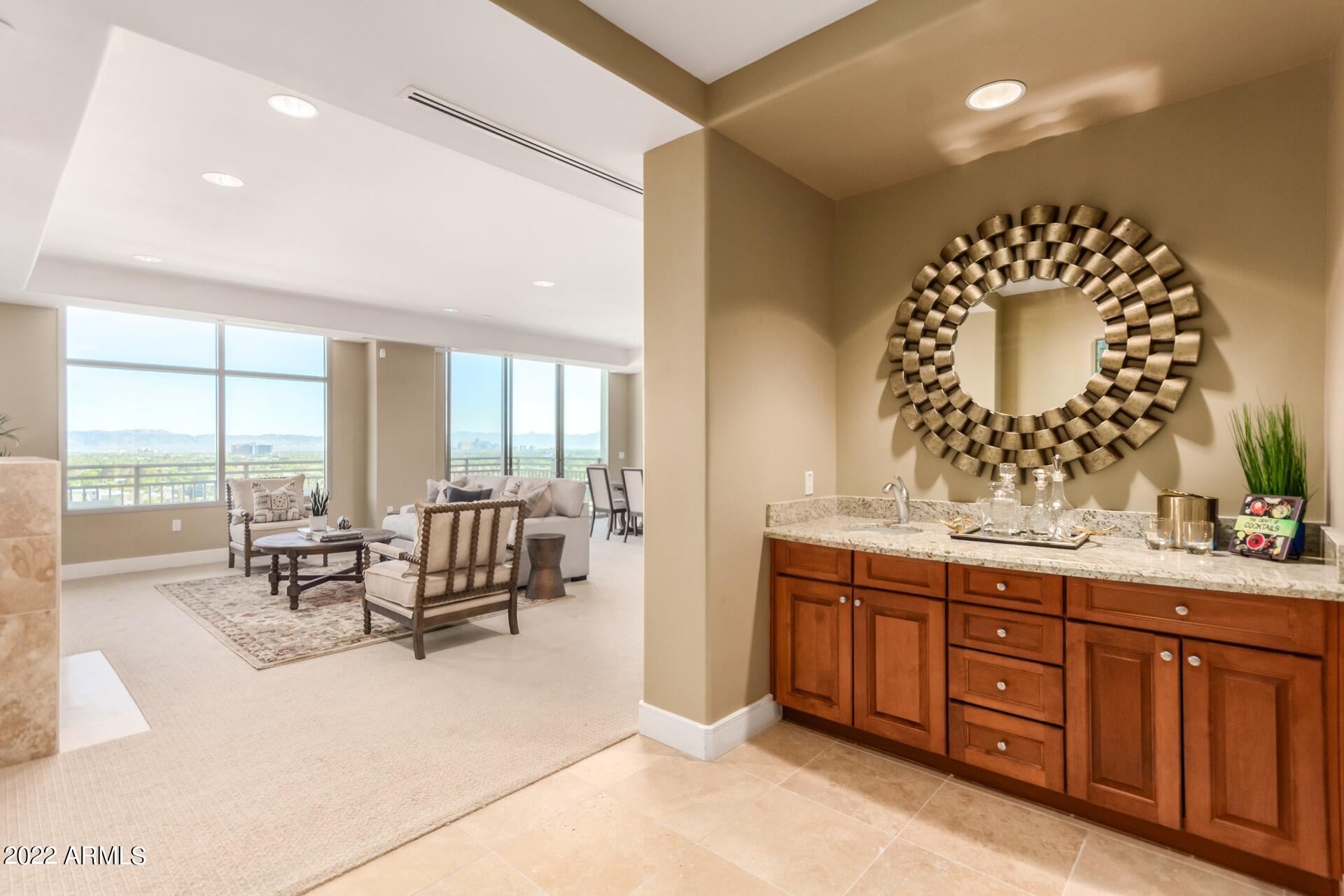 2211 East Camelback Road, Unit 1104 Phoenix, AZ 85016 - Photo 9 of 43 a spacious bathroom with a double vanity sink and a large mirror