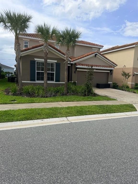 7604 Oakmoss Loop Davenport, FL 33837 - Photo 1 of 16 a view of a house with a big yard and potted plants