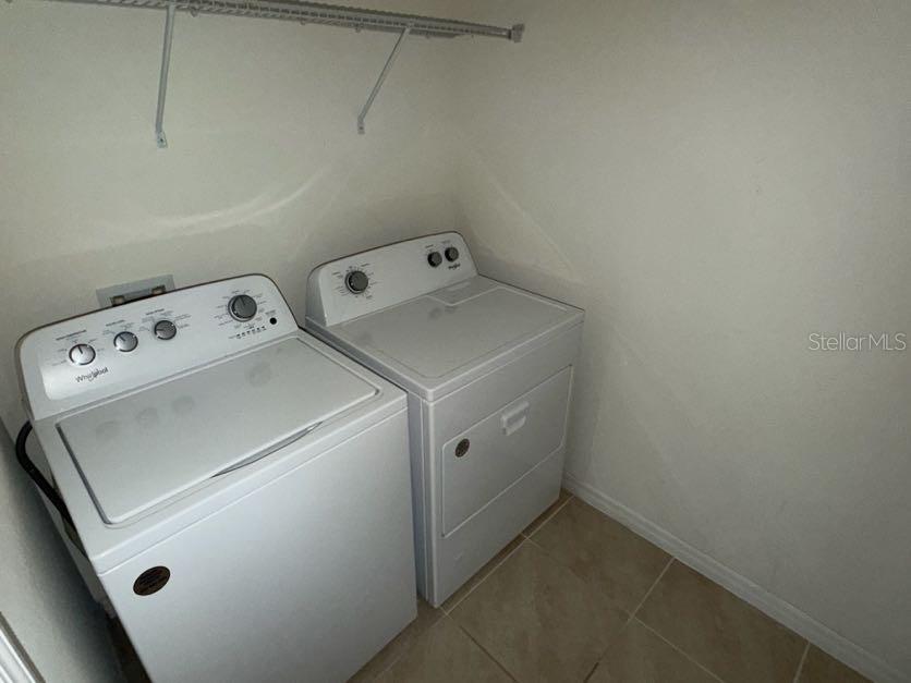 7604 Oakmoss Loop Davenport, FL 33837 - Photo 11 of 16 a utility room with dryer and washer
