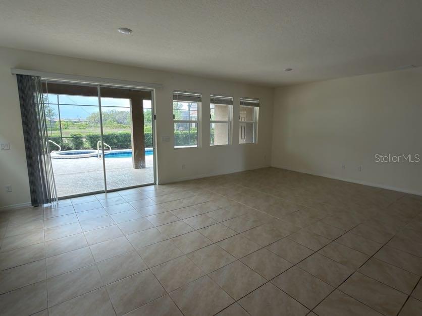 7604 Oakmoss Loop Davenport, FL 33837 - Photo 6 of 16 en empty room with sliding door