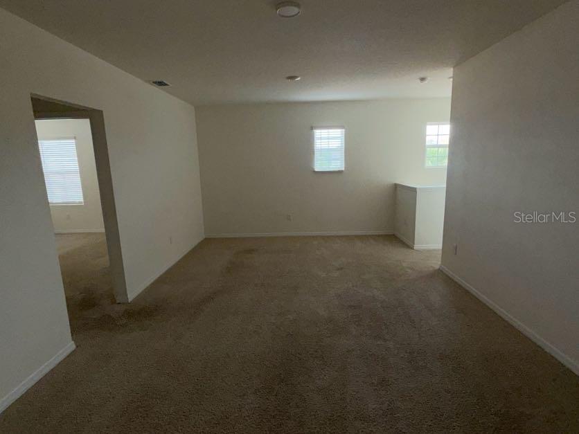 7604 Oakmoss Loop Davenport, FL 33837 - Photo 7 of 16 a view of an empty room with a window