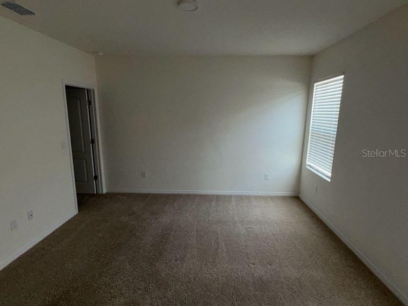 7604 Oakmoss Loop Davenport, FL 33837 - Photo 8 of 16 an empty room with windows