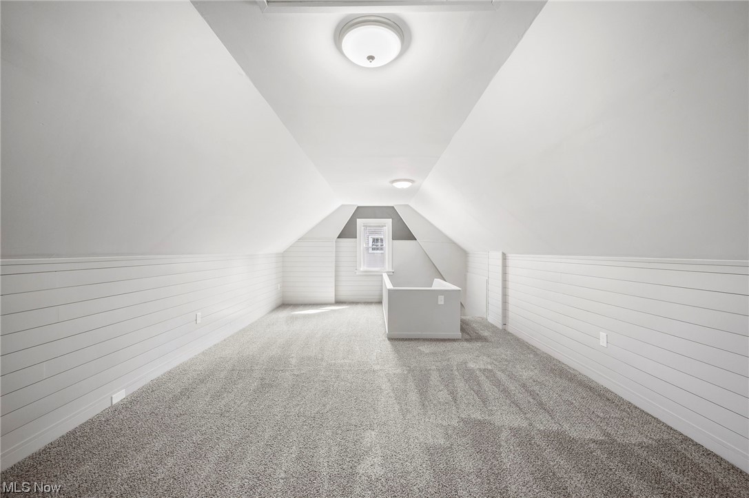 1022 Englewood Road Cleveland, OH 44121 - Photo 28 of 33 Additional living space featuring vaulted ceiling and light colored carpet