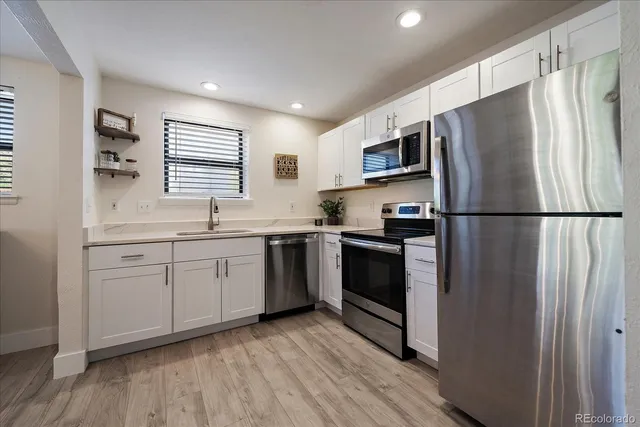 a kitchen with a refrigerator stove and sink