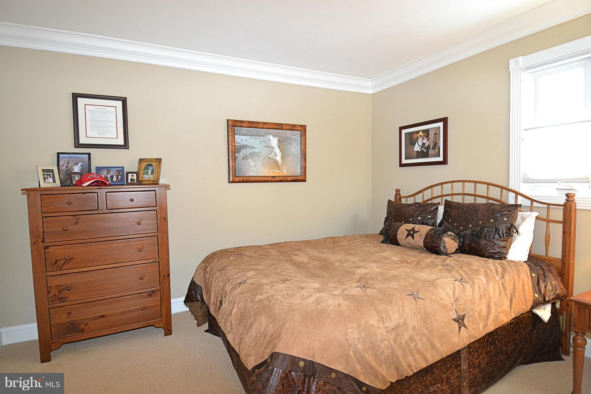11634 Chapel Cross Way Reston, VA 20194 - Photo 19 of 30 a bedroom with a bed and a dresser