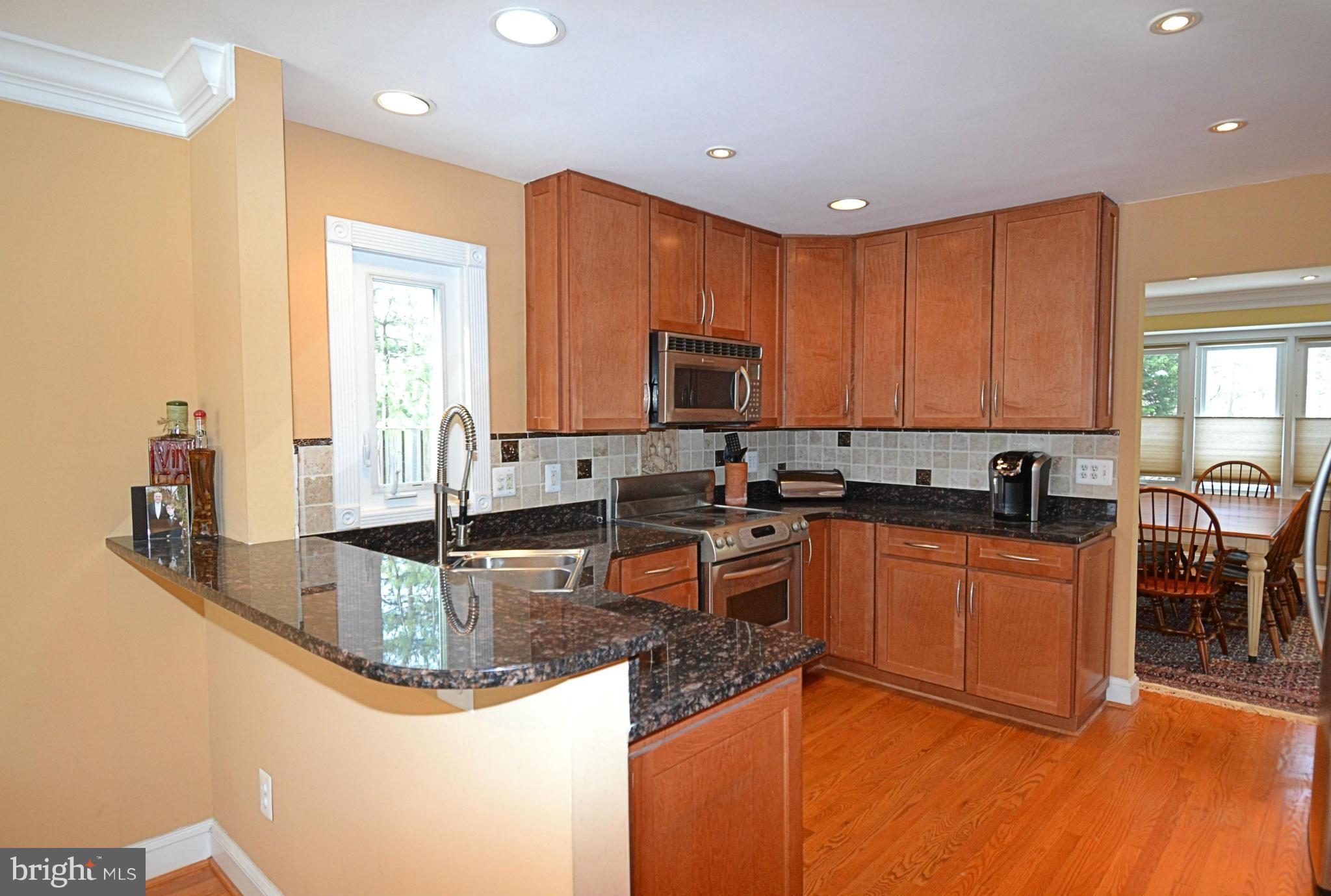 11634 Chapel Cross Way Reston, VA 20194 - Photo 3 of 30 a kitchen with granite countertop a sink counter top space and appliances
