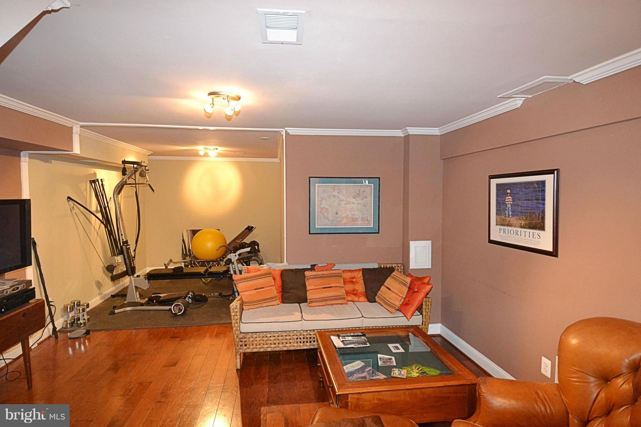 11634 Chapel Cross Way Reston, VA 20194 - Photo 22 of 30 a living room with furniture and a flat screen tv