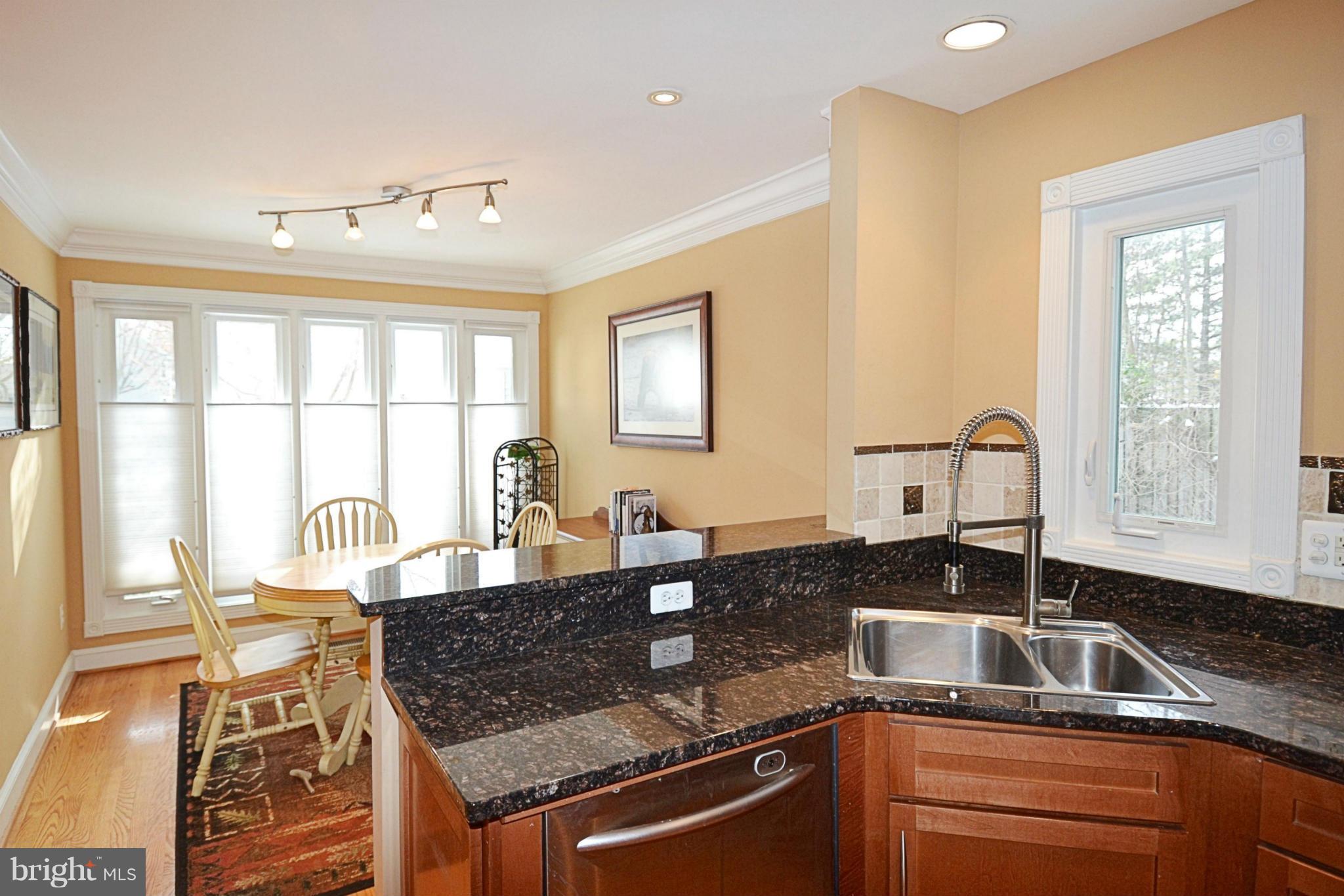 11634 Chapel Cross Way Reston, VA 20194 - Photo 5 of 30 a kitchen with granite countertop a sink and a window