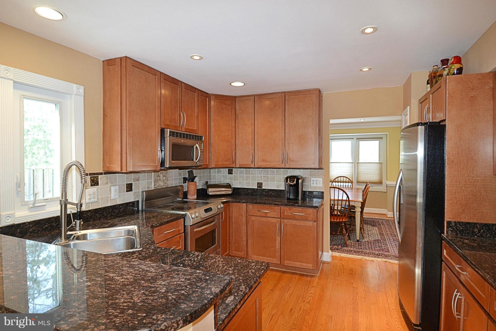 11634 Chapel Cross Way Reston, VA 20194 - Photo 6 of 30 a kitchen with stainless steel appliances granite countertop sink stove top oven and cabinets