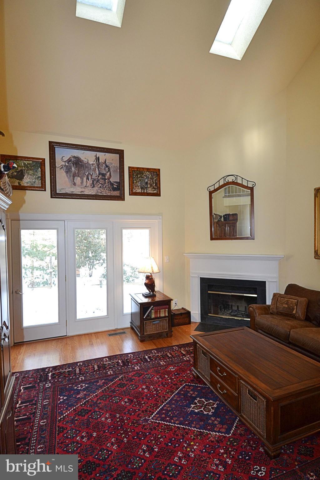 11634 Chapel Cross Way Reston, VA 20194 - Photo 9 of 30 a living room with furniture a flat screen tv and a fireplace