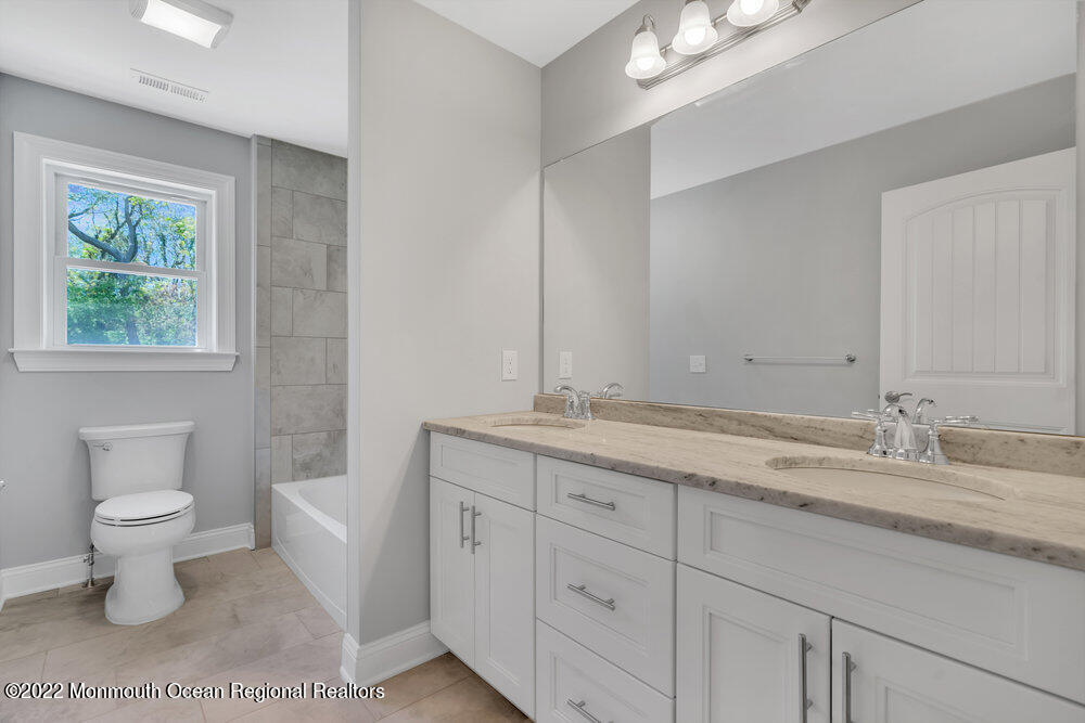 10 Sander Way Bayville, NJ 08721 - Photo 15 of 30 a bathroom with a granite countertop sink a toilet and a large mirror