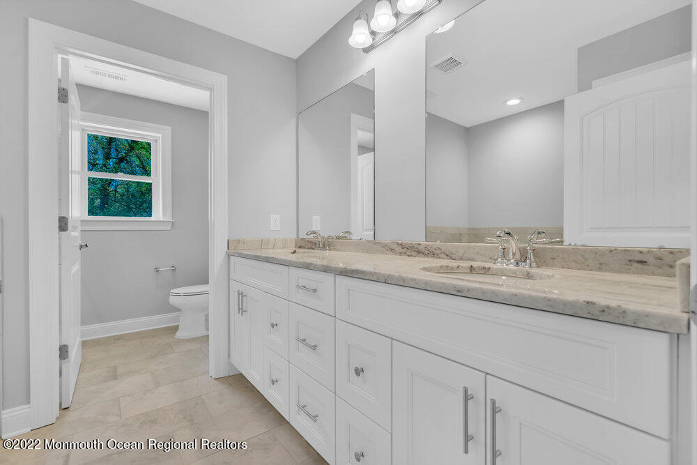 10 Sander Way Bayville, NJ 08721 - Photo 22 of 30 a bathroom with a granite countertop sink and a toilet