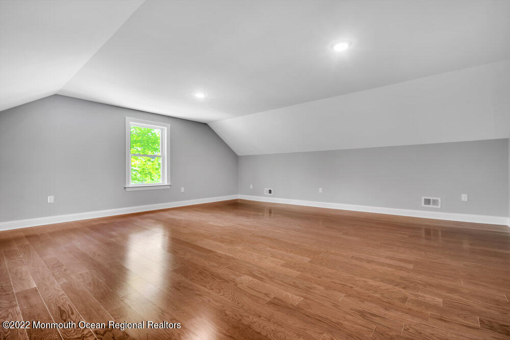 10 Sander Way Bayville, NJ 08721 - Photo 27 of 30 an empty room with wooden floor and windows