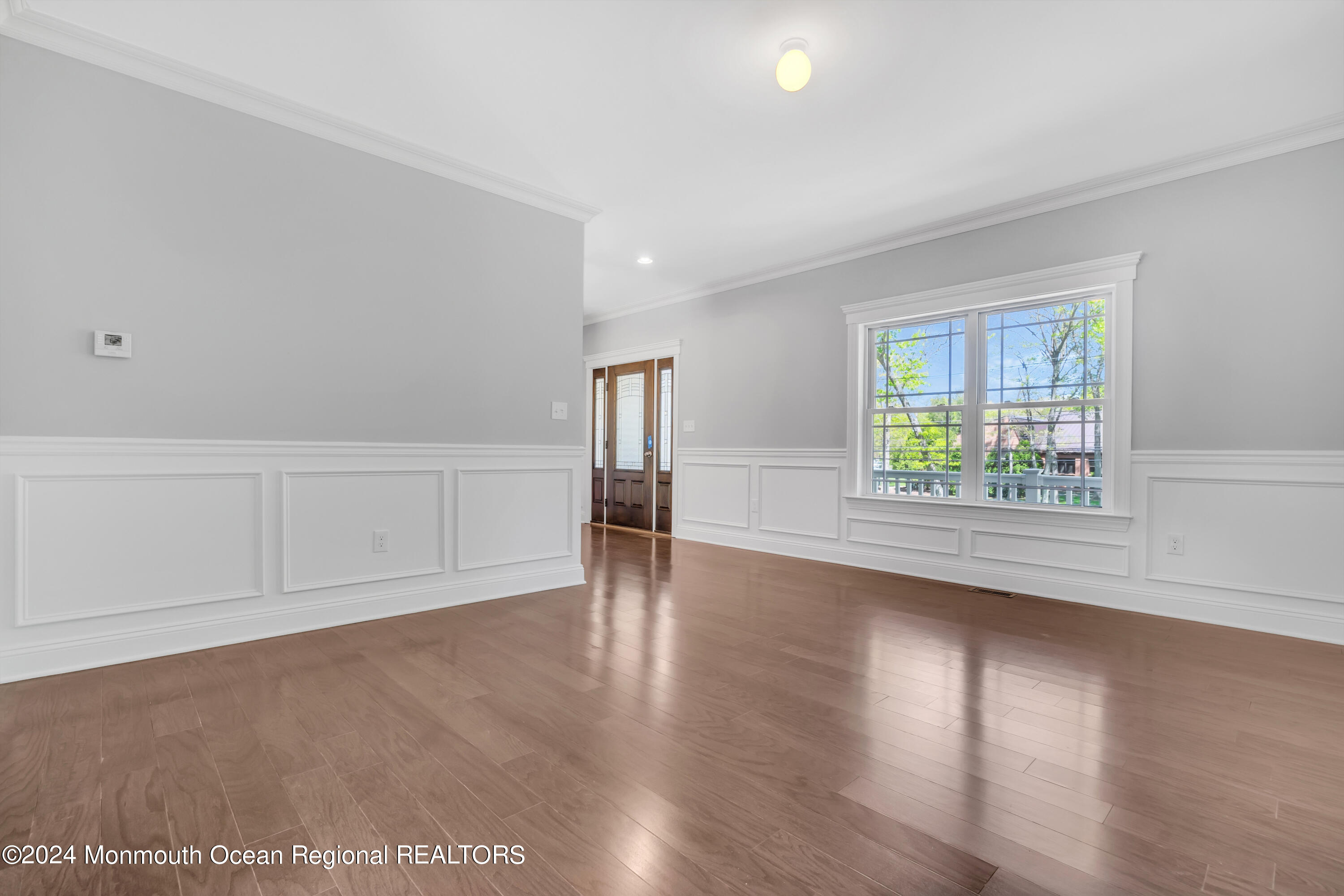 10 Sander Way Bayville, NJ 08721 - Photo 4 of 30 an empty room with wooden floor and windows