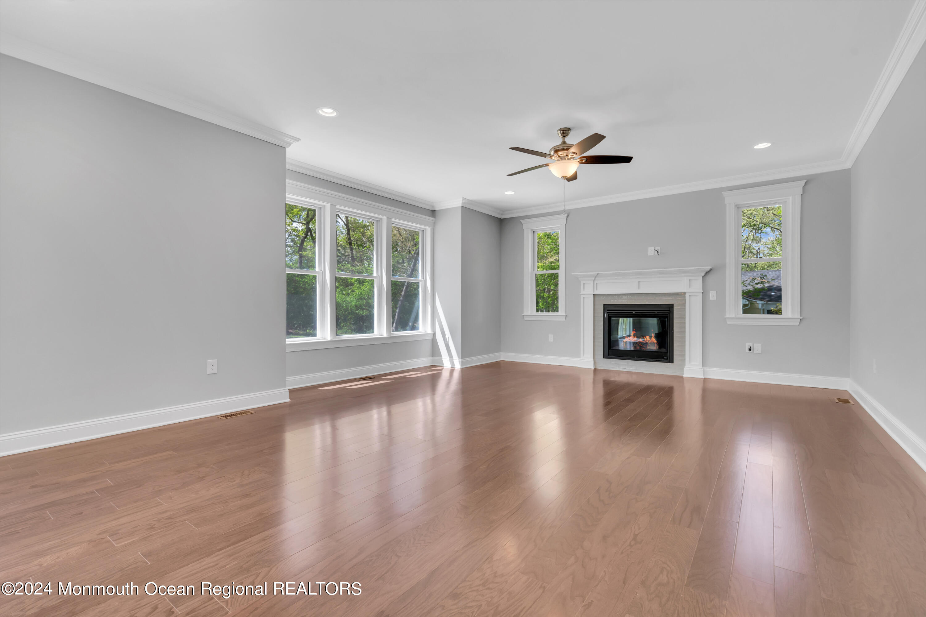 10 Sander Way Bayville, NJ 08721 - Photo 10 of 30 an empty room with wooden floor fireplace and a window